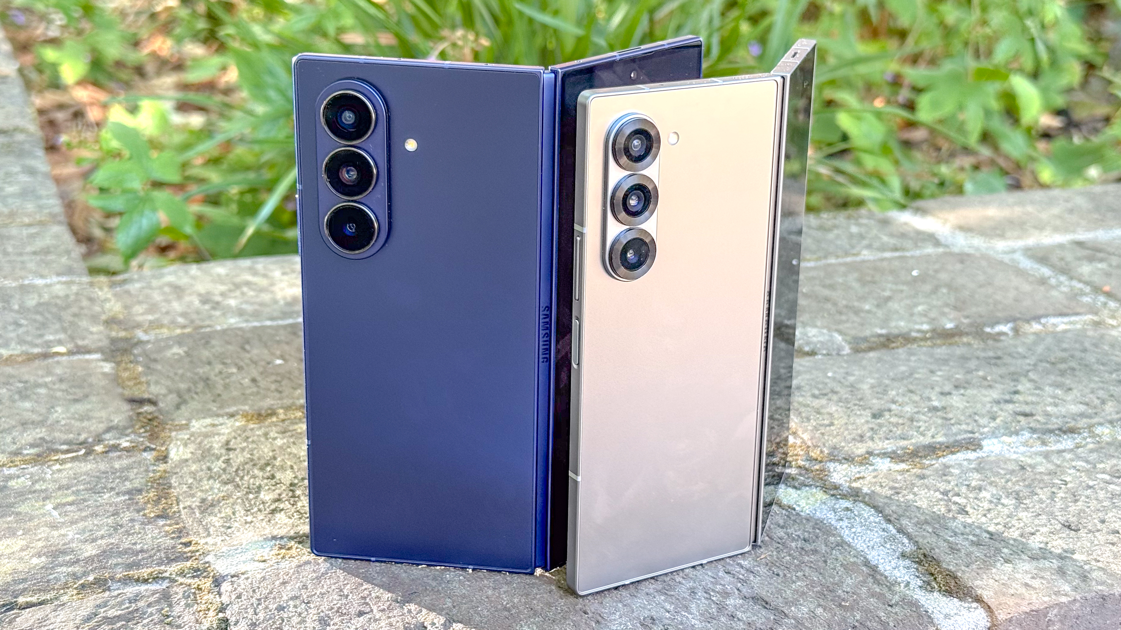Galaxy Z Fold 7 and Galaxy Z Fold 6 shown on a stone wall