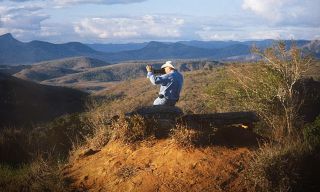 Man taking photos in wilderness landscape