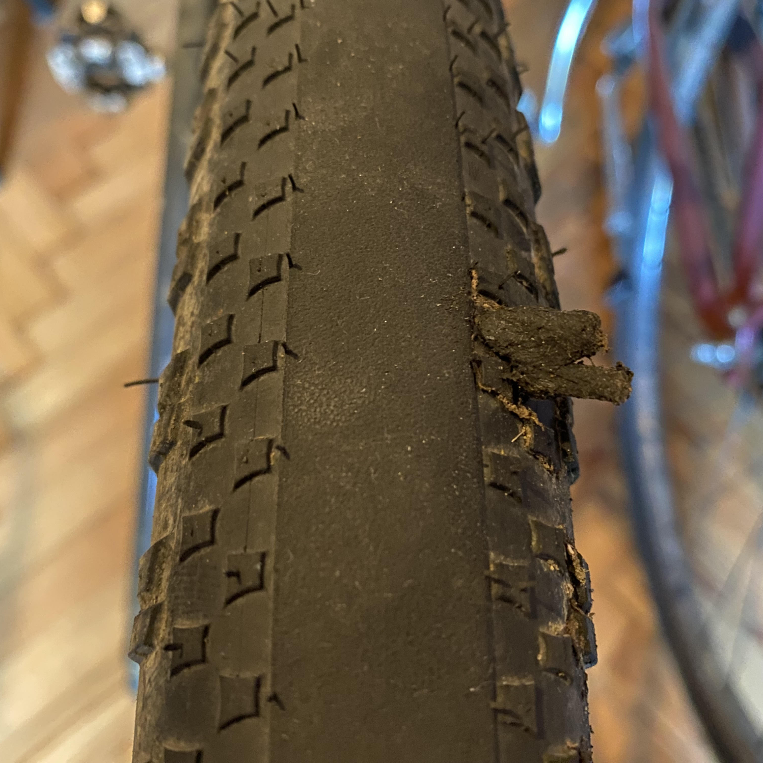 Hutchinson Caracal Race with a large puncture hole, plugged with a tubeless tyre repair worm.