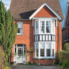 house exterior with brick walls and vintage sash windows