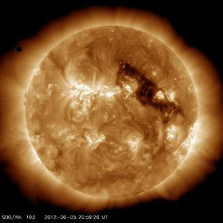The planet Venus (upper left) approaches the sun for a rare solar transit on June 5, 2012. This image was captured by NASA's Solar Dynamics Observatory.