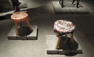 Three legged stools with fabric cover on seat