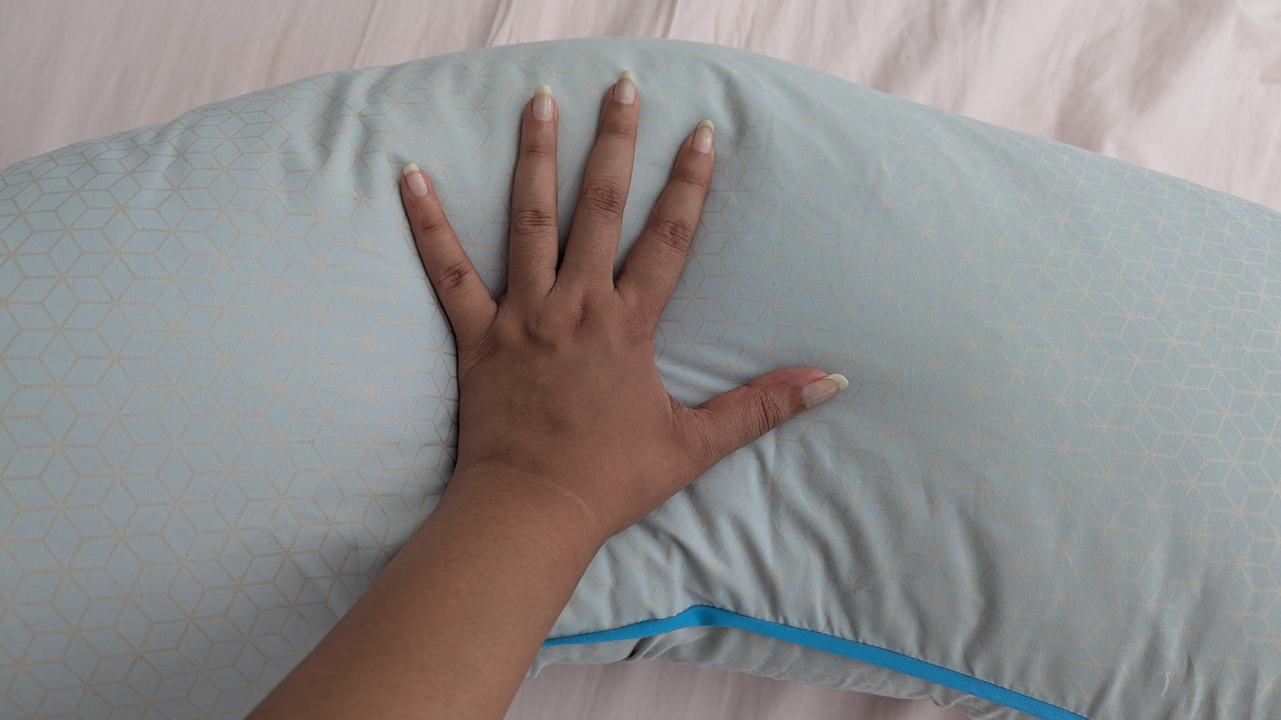 Hands feeling the surface of the Simba cooling body pillow