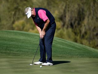 Colin Montgomerie hitting a putt on the green