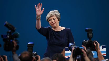 Theresa May waves to the Tory faithful