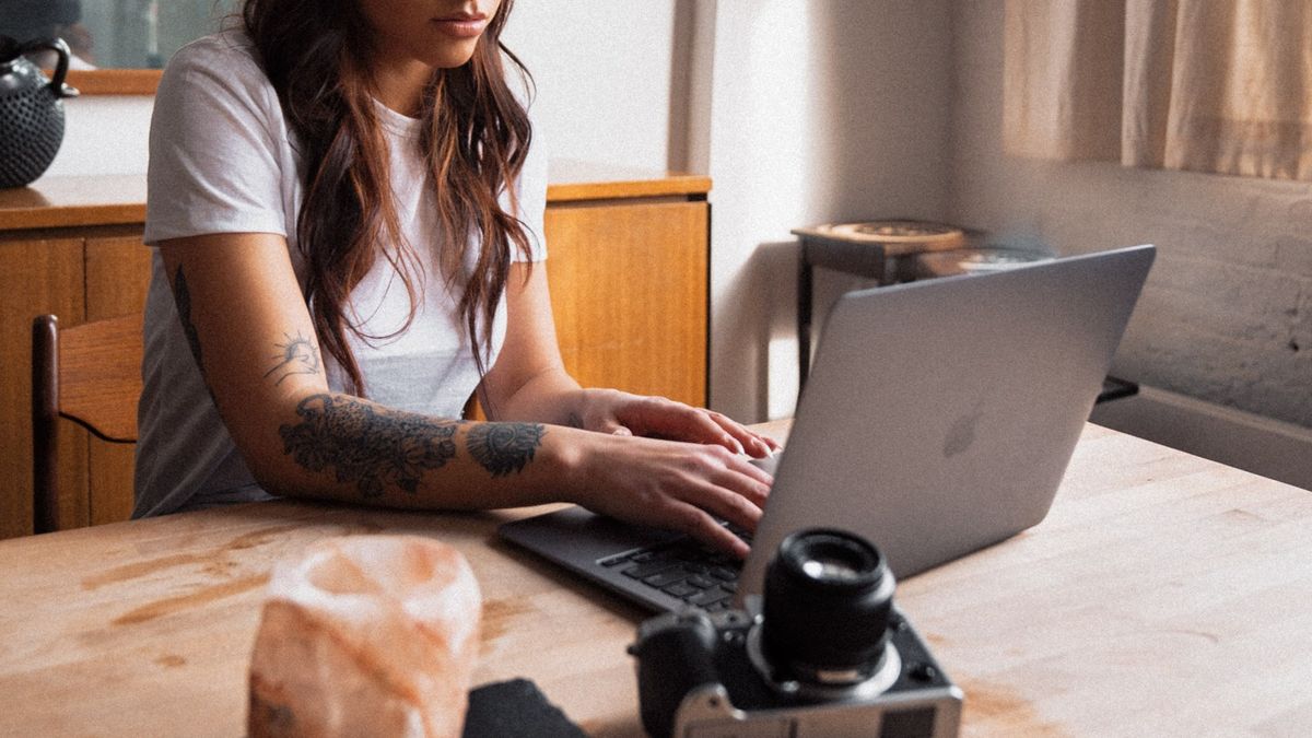 A woman on a laptop - perhaps an editor using this video editing for beginners guide