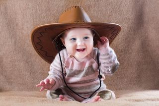 baby wearing a cowboy hat