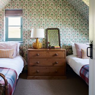 Green wallpaper in twin bedroom