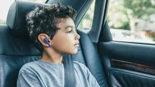 Belkin SoundForm Nano lifestyle image showing a child in a car wearing earbuds