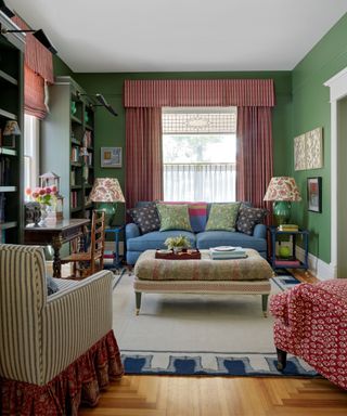 Green decorated living room with red curtains