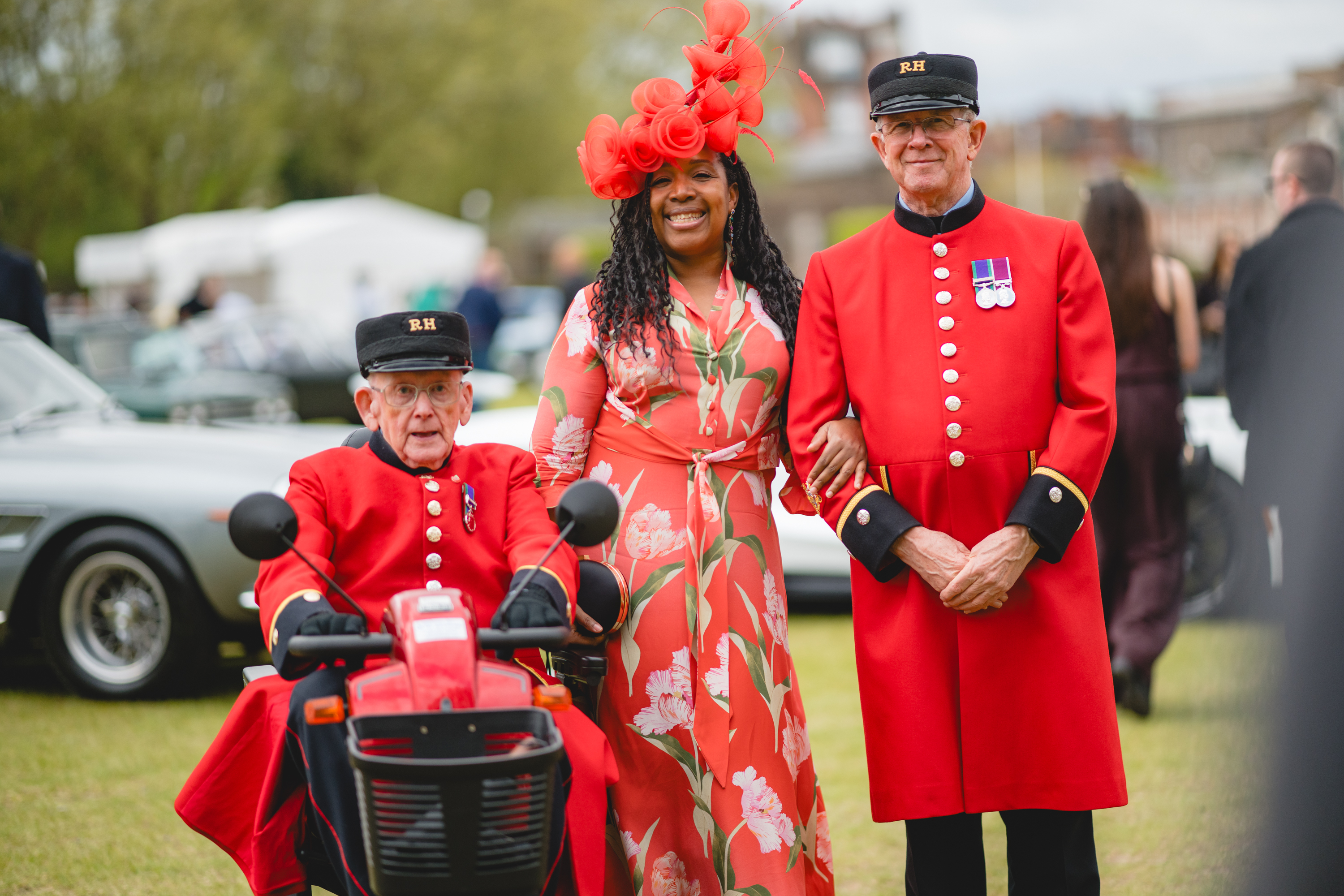Two chelsea pensioners flank a woman