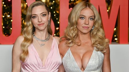 Amanda Seyfried in pink and Sydney Sweeney in sparkling silver both staring at the camera next to one another on The Housemaid red carpet.