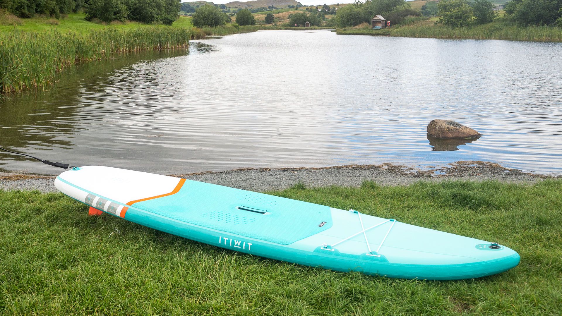 Decathlon X100 SUP touring stand up paddle board on a lakeside