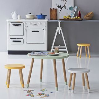 Children's pastel coloured table and stools in a play kitchen
