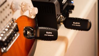 Closeup of the Joyo JW-02 wireless guitar system in use