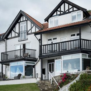 white colour seaside house with gallery