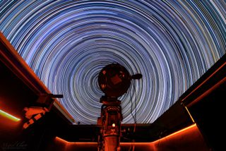 stars are depicted as colorful rings in the sky thanks to a long-exposure photograph. the rings are various shades of blue, red, yellow and white