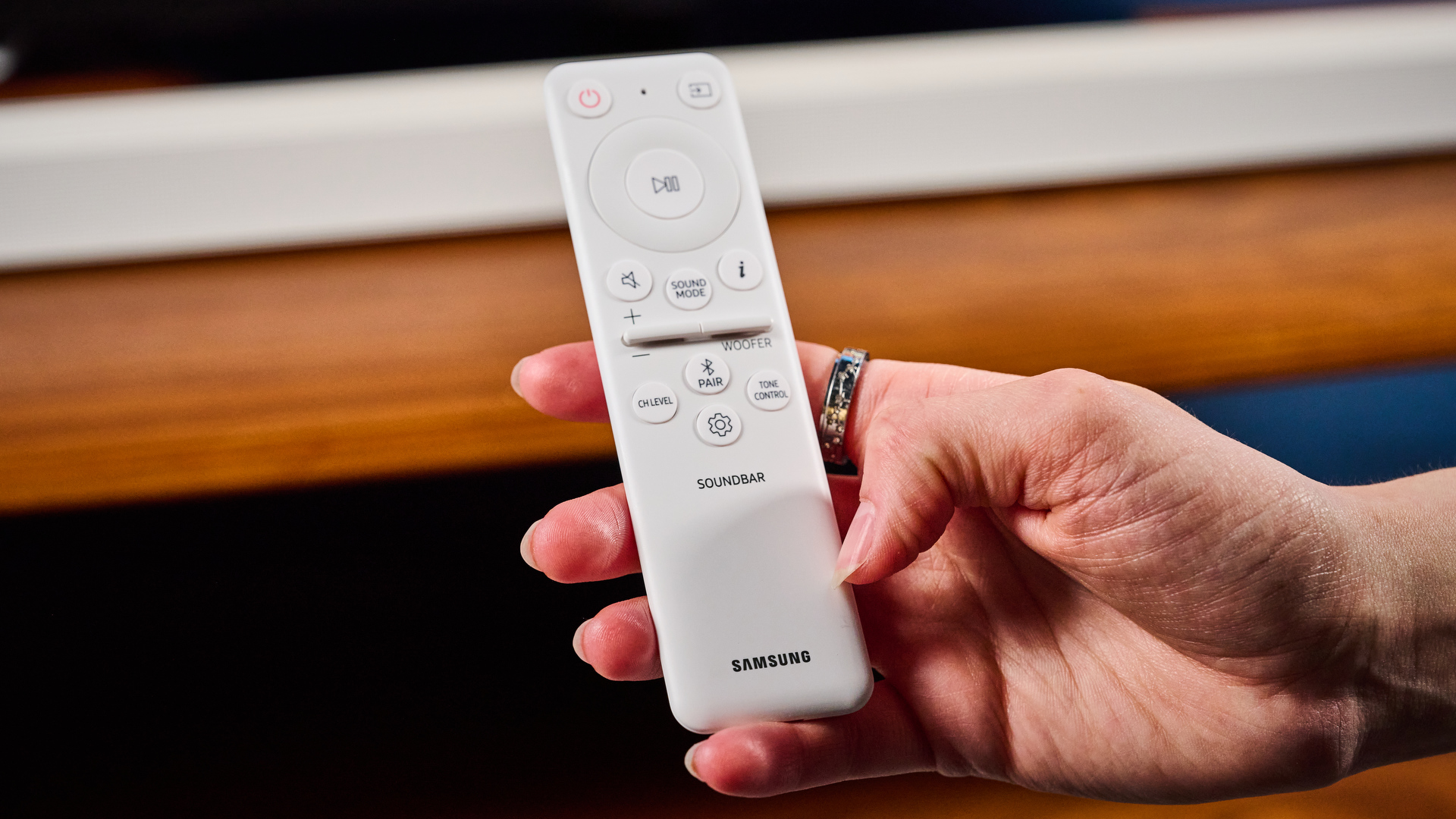 the samsung hw-s801d soundbar and subwoofer in white, an ultra slim soundbar with on-bar buttons, a remote, and separate subwoofer with a black cone