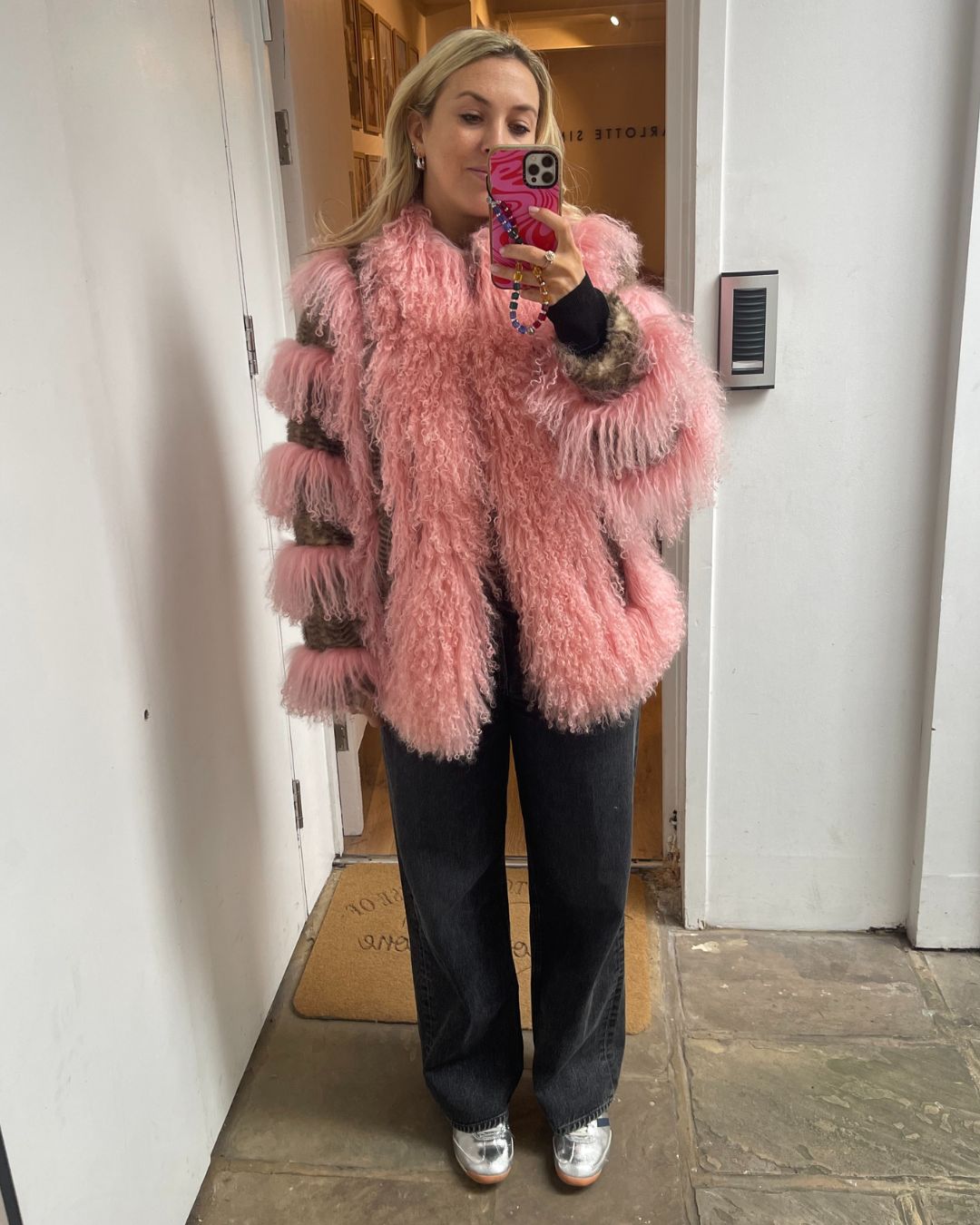 Clementina Jackson tries on the charlotte simone floyd coat