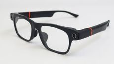 The Solos AirGo Vision smart glasses sitting on a white table