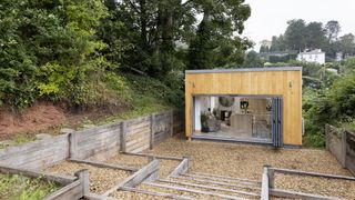 self build with open bifold doos and timber cladding