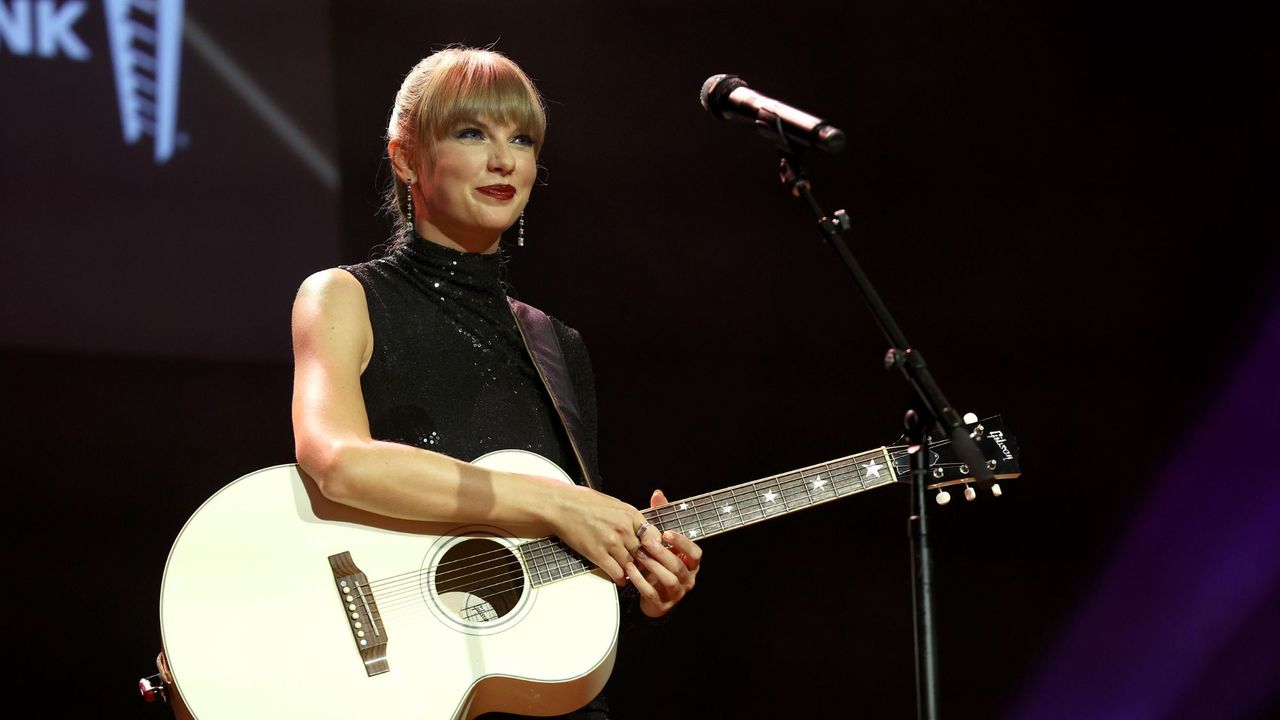 Taylor Swift plays the guitar on stage in Nashville, Tennessee