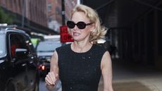 Pamela Anderson wearing black sunglasses and a black dress in NYC
