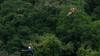 People tackling the zipline course in Rincón de la Vieja National Park, Costa Rica