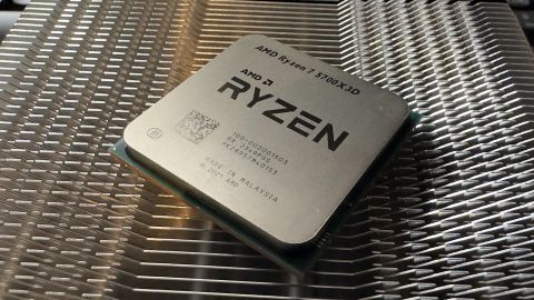 A photo of an AMD Ryzen 7 5700X3D processor resting on a metal heatsink