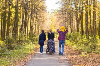 A family walking on a path in the woods.