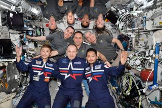 The Soyuz MS-20 crew (front row) poses for a group portrait with the Expedition 66 crew. Front row, from left, are Yusaku Maezawa, Alexander Misurkin and Yozo Hirano. In the middle row, from left, are Pyotr Dubrov, Anton Shkaplerov and Mark Vande Hei. In the back, from left, is Matthias Maurer, Thomas Marshburn, Raja Chari and Kayla Barron.