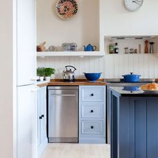 tongue and groove splashback kitchen with freestanding stainless steel dishwasher white panelling and walls blue units and island