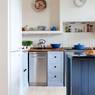 tongue and groove splashback kitchen with freestanding stainless steel dishwasher white panelling and walls blue units and island