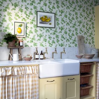 bathroom with country inspired interior, wallpaper, sink and art.