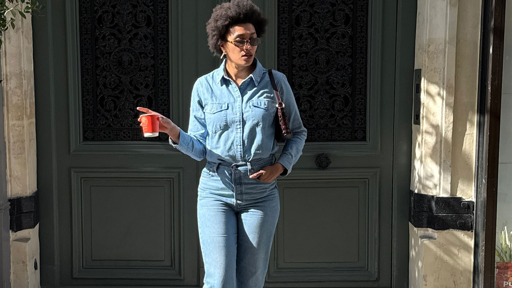 A French woman wearing cropped flared jeans and heels.