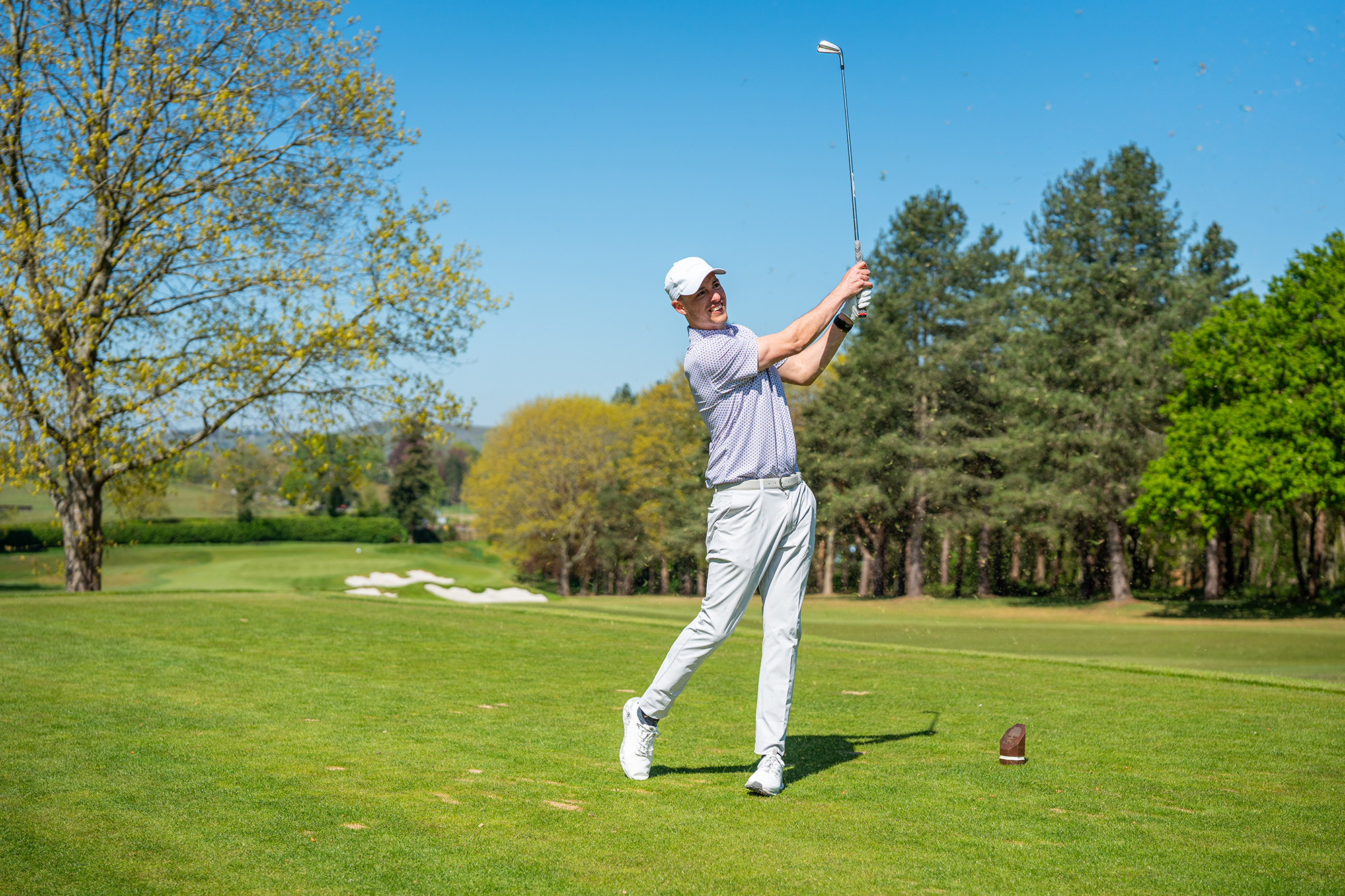 Joel Tadman hitting a pitching wedge off the tee on the par-3 at Tandridge Golf Club