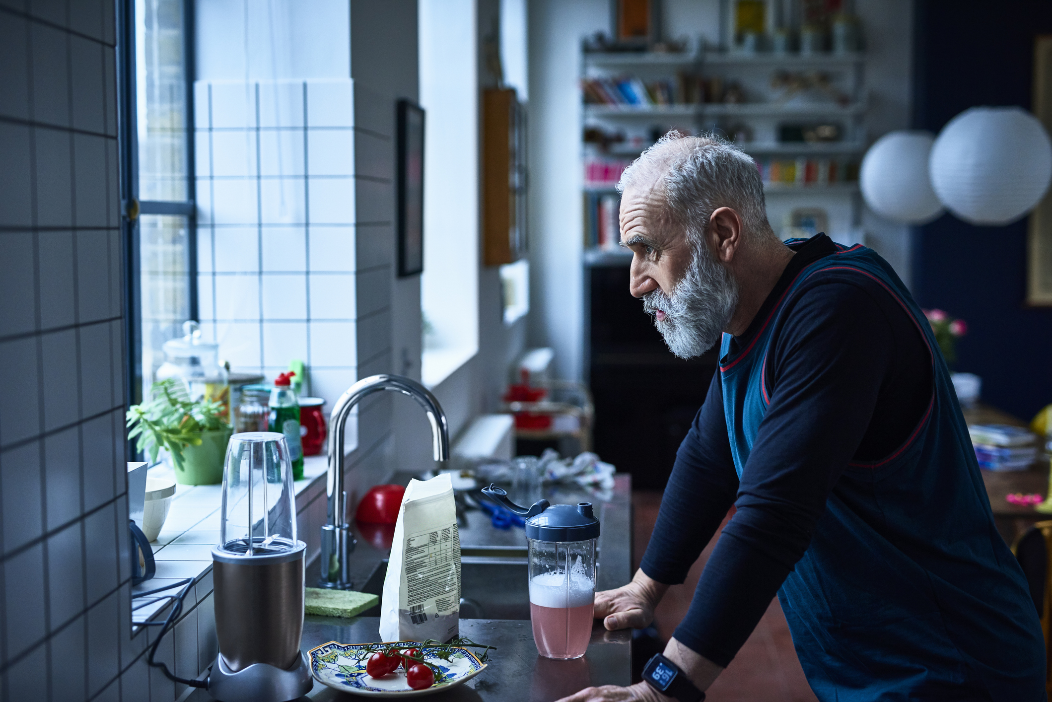 Retired man looking worried at sink