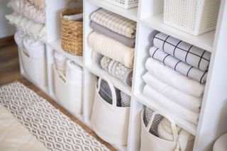 Shelving with neatly folded laundry and storage containers