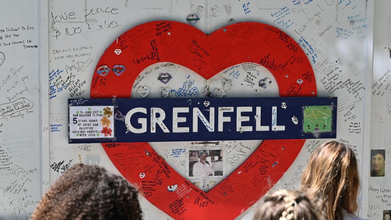 Observers attend Grenfell Memorial Wall