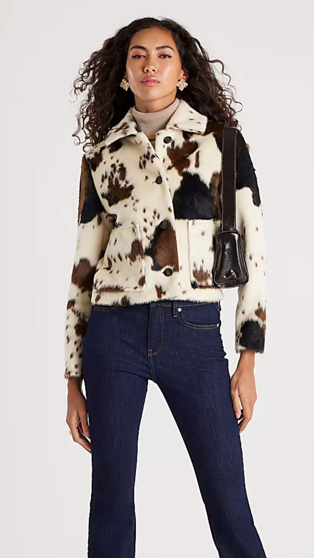 a model wearing the river island cow print jacket
