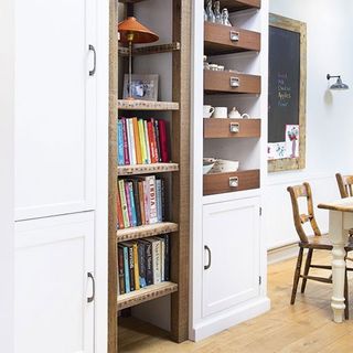 kitchen room with wooden flooring and bookshelves