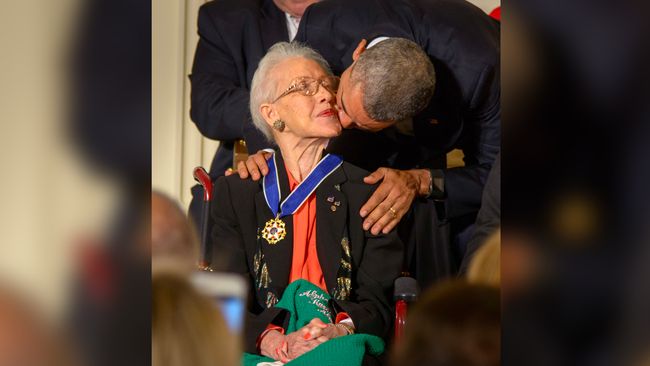 President Barack Obama presents former NASA mathematician Katherine Johnson with the Presidential Medal of Freedom, as professional baseball player Willie Mays, right, looks on, Tuesday, Nov. 24, 2015, during a ceremony in the East Room of the White House in Washington.
