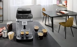 The De'Longhi Magnifica Evo on a table surrounded by food