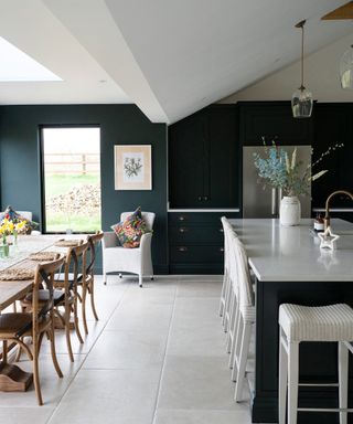 blue open plan kitchen diner with stone floor