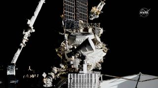 NASA astronaut Andrew Morgan rides a robotic arm while working outside the International Space Station on a spacewalk repair of the $2 billion Alpha Magnetic Spectrometer on Jan. 25, 2020.