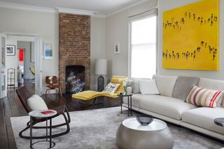 White living room with bright yellow artwork