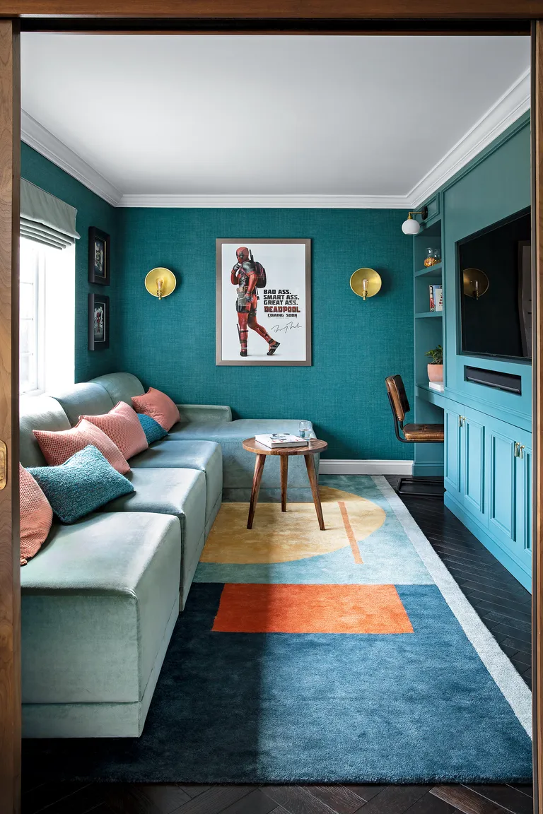 Cinema room with blue chaise-style sofa and Ellsworth Kelly inspired rug