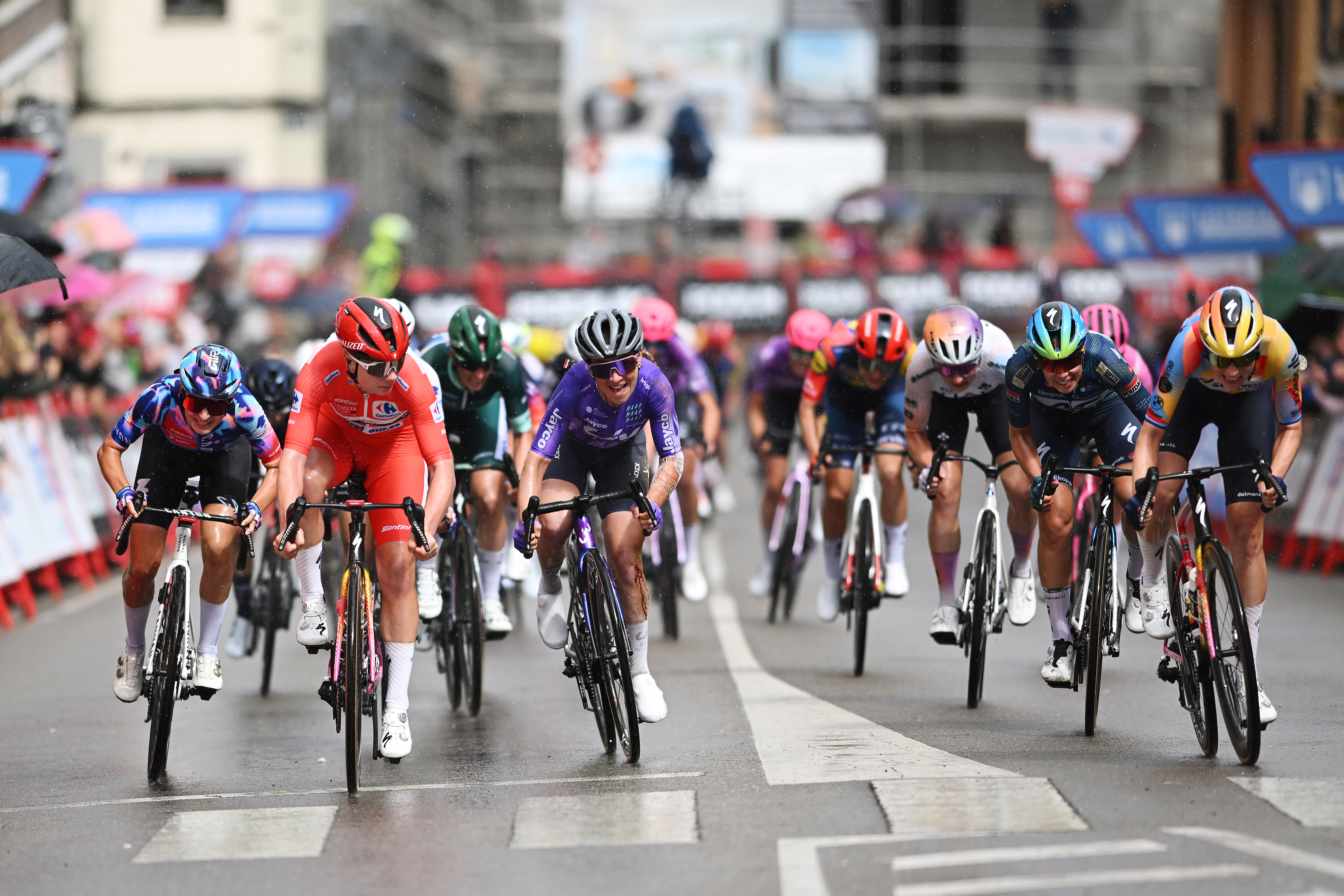 Lotte Kopecky in red gifts stage win to team mate Mischa Bredewold (far right) at Vuelta Femenina