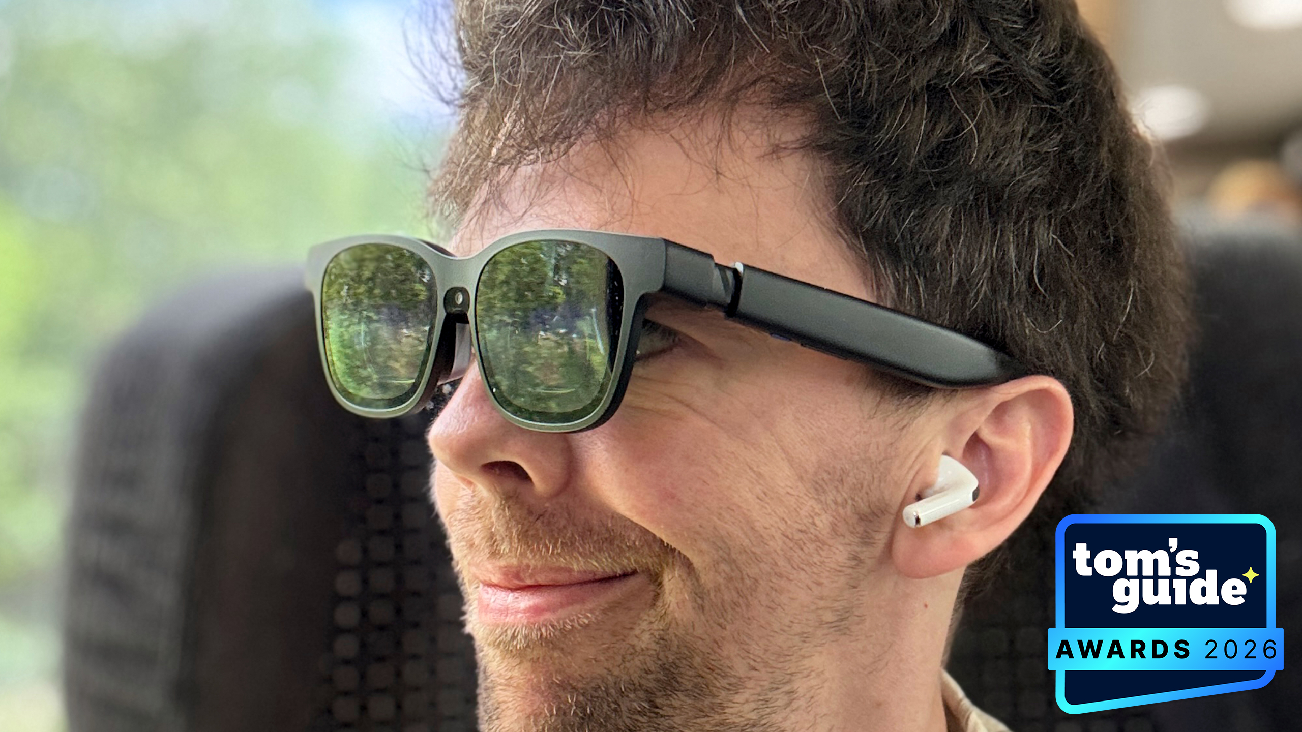 A person wearing the Viture Beast AR glasses with a TG Awards 2026 badge