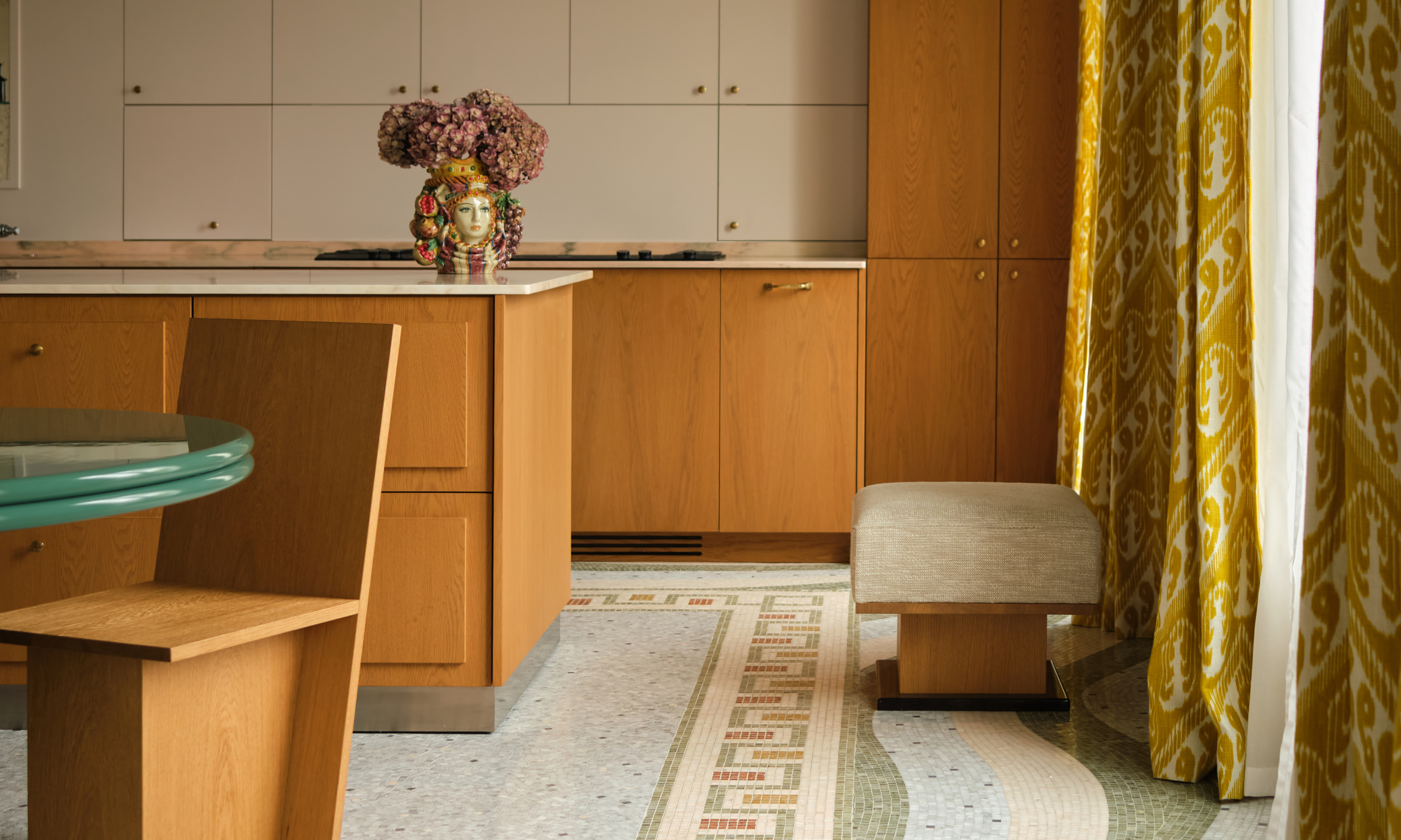 Oak wood kitchen with cream upper cabinets, mosaic tiled floor